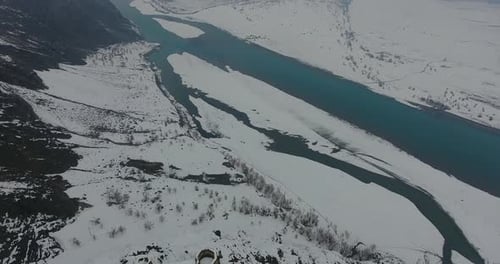 Aerial view of snow-covered mountains and river in winter, Pakistan.