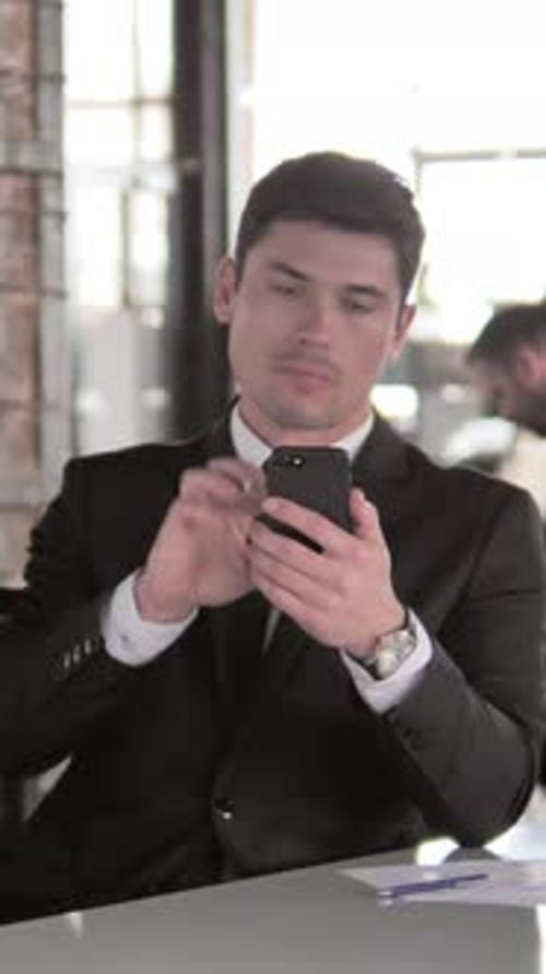 Businessman Using Smartphone in Office, Vertical Video