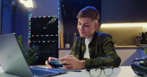 Young Man Plays Video Game in Room at Night