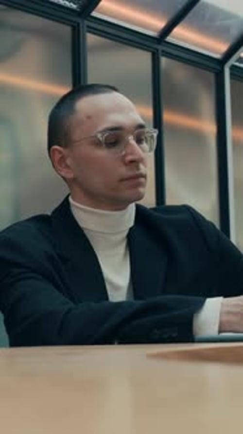Vertical of Eccentric Man Dancing at Desk in Office
