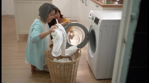Woman and Younger Woman Doing Laundry at Home