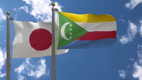 Flags of Japan and Comoros Waving Against Blue Sky