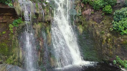 Aerial drone footage of a tall rocky waterfall in the Yorkshire Dales, Pennies. Moorland scene of a