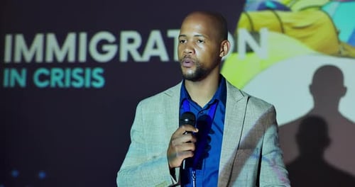 Black man, talking or tablet at presentation for information, news or immigration crisis awareness