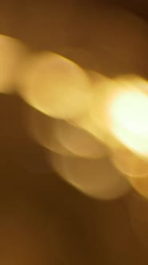 Golden bokeh light leak overlay transition with defocused glow