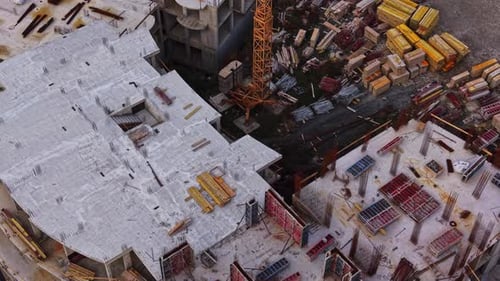 Construction site viewed from above with materials and equipment scattered