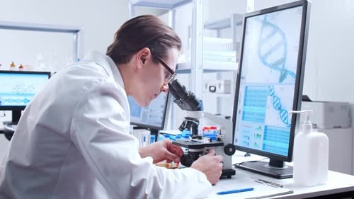 Scientist Uses Microscope in Bright Research Laboratory