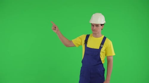 Medium Green Screen Isolated Chroma Key Video of a Young Construction Worker Looking to the Side of