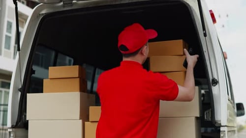 Delivery man, driver calling to customerr for sending parcel box package in the cargo truck at home