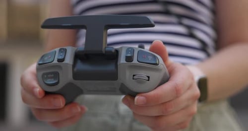 Woman's Hands Navigating Dji Avata Drone Remote Control - Close Up