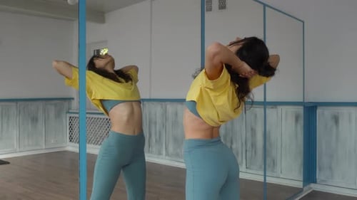 Woman Practicing Poses and Dance Moves in Studio