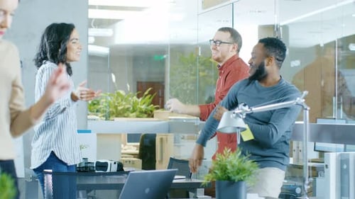 Diverse Group of Young Women and Men Dance and Have Fun in the Modern Office.