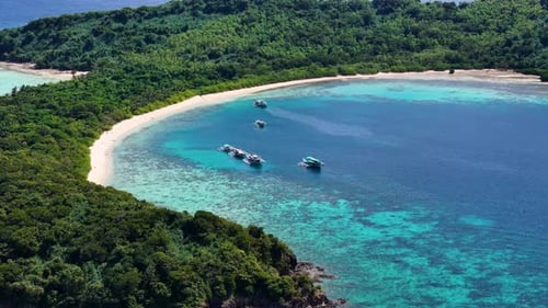 Stunning drone shot of Bulog Dos Island, with its clear blue waters and tropical island beauty.