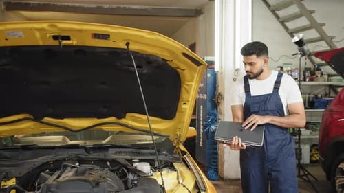Bearded Man Car Technician Mechanic Repairing Car Problem of Engine During