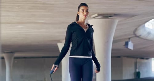 Young Woman Exercising with Jump Rope in Urban Setting