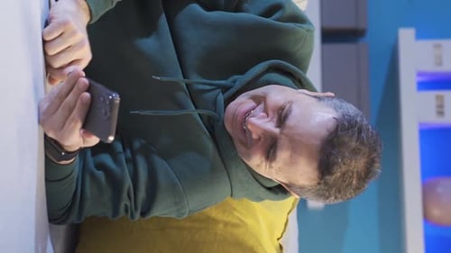 Man Lying on Couch Using Mobile Phone