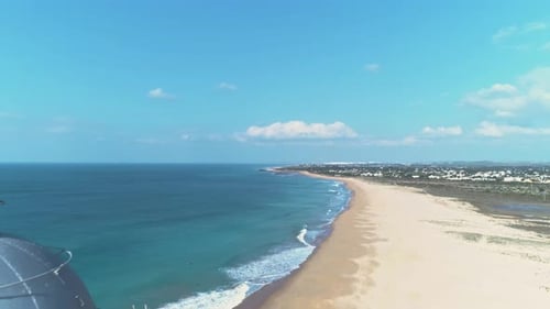 Reveal aerial view of the iconic Trafalgar lighthouse building on Spanish beach