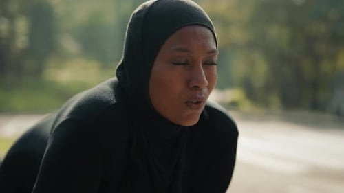 Exhausted Woman in Hijab Breathing Heavily After a Long Run