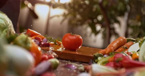 Cutting tomato on wooden board