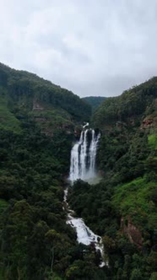 Approaching spectacular waterfall falling from the picturesque mount.
