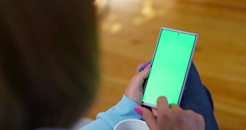 Person Using Smartphone with Green Screen