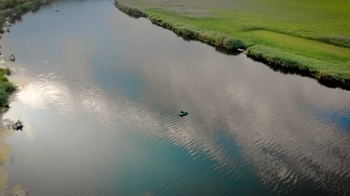 Aerial View of People with Fishing Rod on Rubber Boat in Middle of Lake and on Wooden Bridges