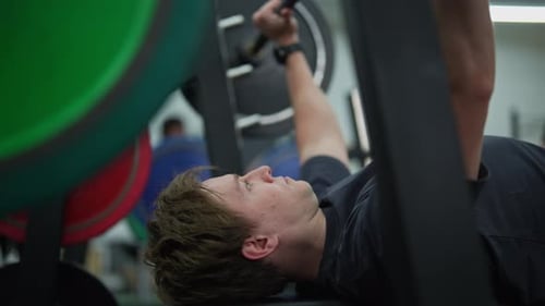 Closeup Side View of Beginner Sportsman Doing Bench Press Workout with Barbell at Gym Closeup of