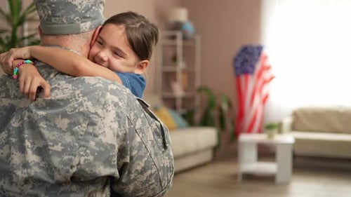 Affectionate Girl Hugging Military Father in Home Interior