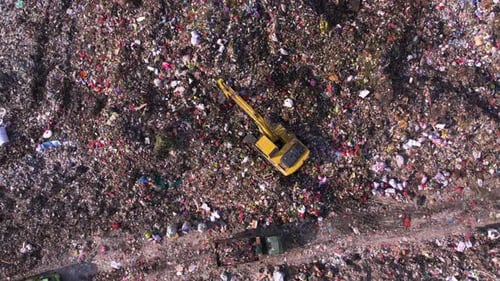 Excavator Sorting Waste at Landfill Aerial View