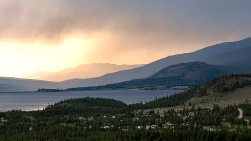 Time lapse of the sun setting behind storm clouds looming over Lake Dillon in Colorado's Rocky Mount