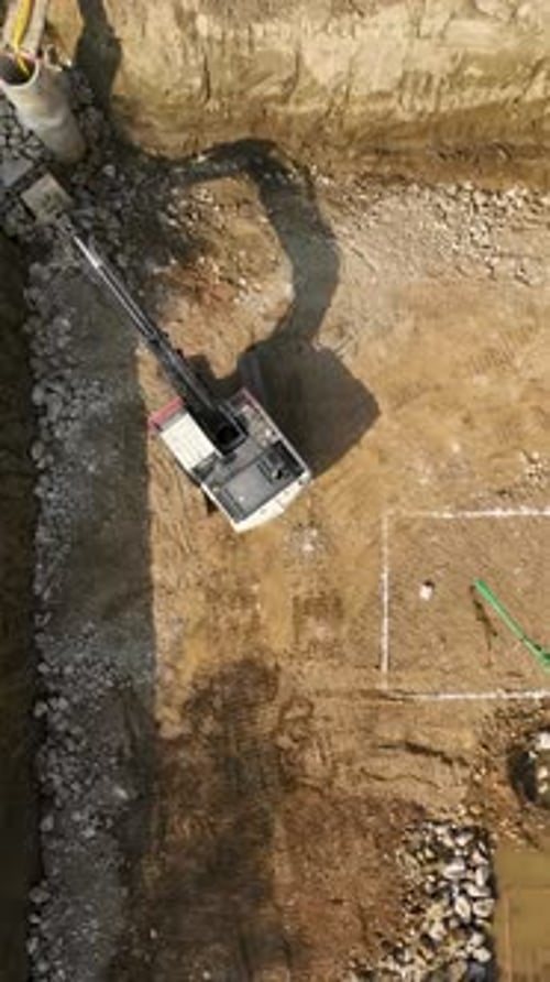 Excavator Working at Construction Site Aerial Shot