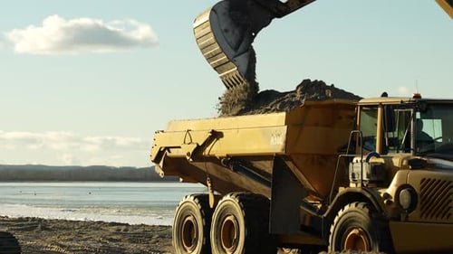 Excavator loading dump truck