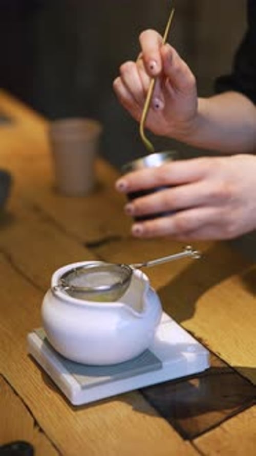 Matcha Process of Making Green Tea in a Bowl on Wooden Table Background