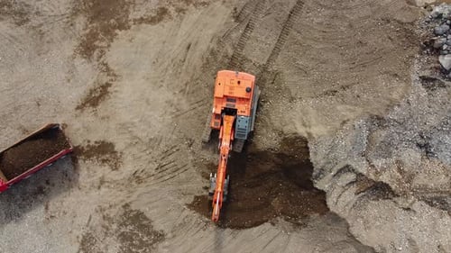 Aerial View of Excavator Digging Dirt