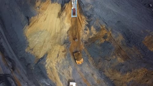 A Stunning Aerial View Showcasing a Massive Mining Excavation Site with Heavy Machinery at Work