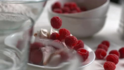 Fresh Raspberries Falling on Delicious Dessert Cake