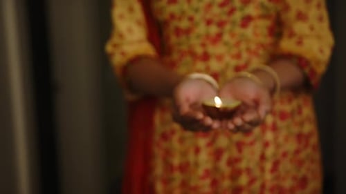 Hands Holding a Diya Lamp Close Up