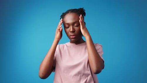 Woman Massaging Head Due to Headache Pain