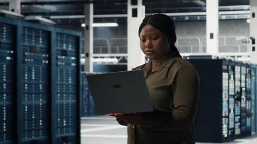 Data Center Engineer Using Laptop to Develop Disaster Recovery Plans