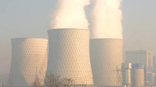 Video shows thick smoke rising from the cooling towers of a thermal power plant, illustrating indust
