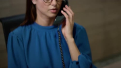 Closeup Businesswoman Hand Taking Telephone in Office. Corporate Secretary Talking Telephone With