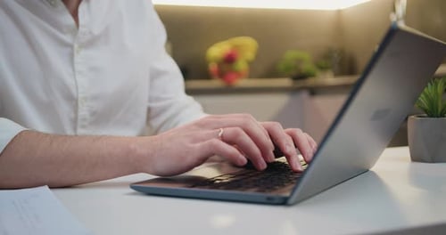 Close Up Male Hands of Unrecognizable Male Man at Table Typing Computer Keyboard Online.