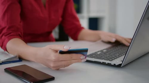 Woman Typing on Laptop, Holding Credit Card