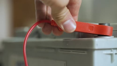 Red Cable Attaching to Car Battery