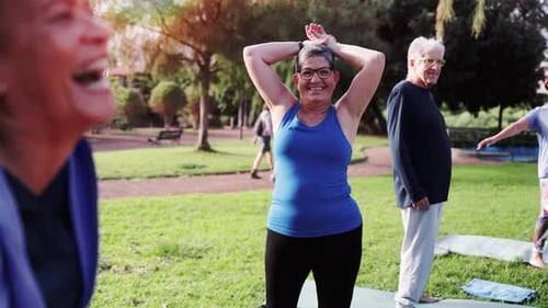 Senior people exercising during sport yoga workout class outdoors at park city. Fitness joyful Elder