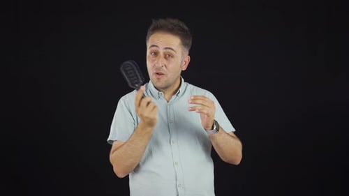 Man Brushing Hair Showing Hair Loss