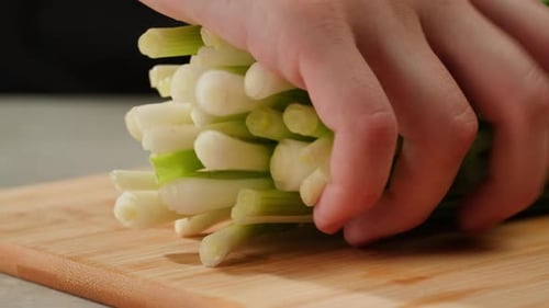 Cutting Fresh Green Onions on a Cutting Board Close Up Chef Cooking Green Vegan Salad