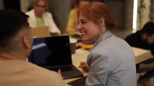 multigenerational coworkers chatting in office, coworking