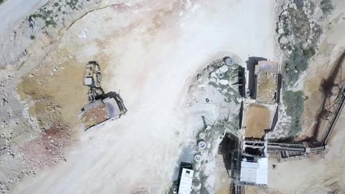 Stone sorting station in a large Quarry, with rocks transported on conveyor belts, Aerial view.
