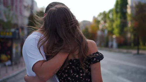 Panning Around Young Handsome Man Kissing Gorgeous Slim Woman Standing on City Street Talking and